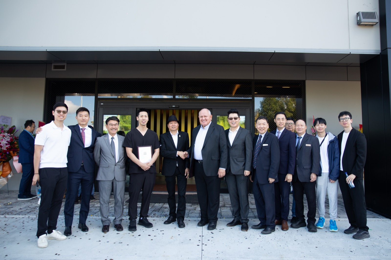 Guests at the opening gathered for a group photograph outside the entrance of the new medical facility